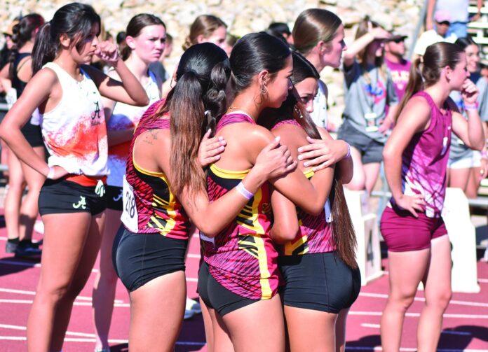 The Española Valley 4x800 meter relay team shares an embrace after finishing seventh in the event Friday at the Class 4A-5A state championship meet in Albuquerque.