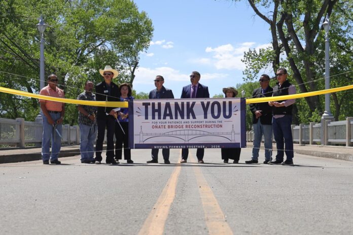Santa Clara Gov. James Naranjo (left), Española Fiesta Council President Tito Terrazas, Española Chamber President Adam Enciñas, NMDOT Engineer Rhonda Lopez, Española Mayor Dennis Tim Salazar, Española City Manager Michael Ortiz, Bridge Reopening Committee Chair Nanette Valerio, Ohkay Owingeh Sheriff Brandon Cata and NMDOT acting cabinet secretary David Quintana prepare to cut the ribbon to reopen the Oñate Bridge on May 12.