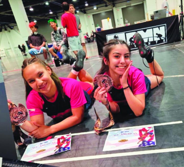 Rising Española Valley junior Jazlynn Maestas (right) was fourth in 15U and Española alum Allysandra Sanchez (left), who is also wrestling at Hiram College in Ohio, took fourth in 18U.