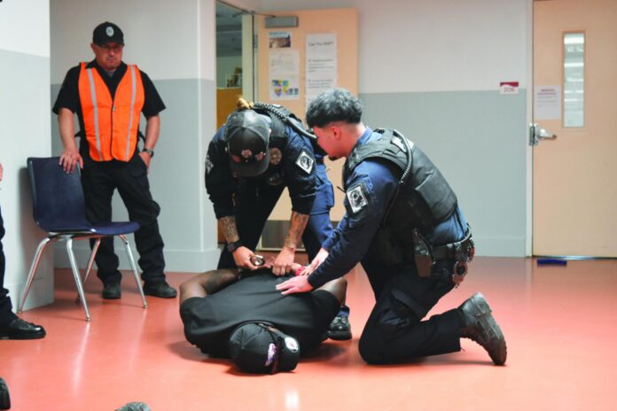 In one scenario, officers handcuff a shooter, played by Detective Dominic Ellis.