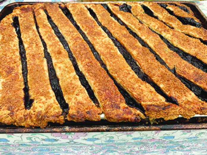 This cherry slab pie swaps a pie tin for a rimmed sheet pan, round or rectangular.
