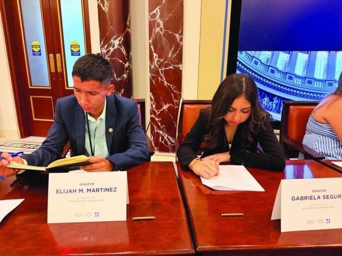 Elijah Martinez and Gabriela Segura working on model AI legislation.
