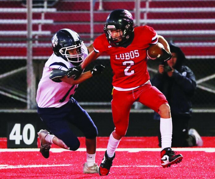 Escalante senior Jacoby Valdez, looking for yardage in a game last season, is the top returning running back for the Lobos.