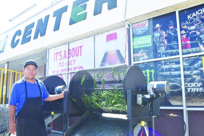 New Mexico green chile season has begun and vendors throughout the state are roasting chile for consumers. Center Market employee Luis Enrique was manning the roaster Monday morning.