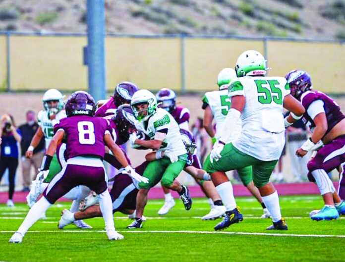 Pojoaque Valley running back Jonah Villegas looks for some room against Belen in a game the Elks lost 47-6 last week.