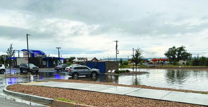 Heavy rain last week caused flooding on various streets in and around Española. It also turned the 7Brew parking lot into a shallow wading pool, though the water didn’t deter some customers. Heavy rain is expected again through Friday.