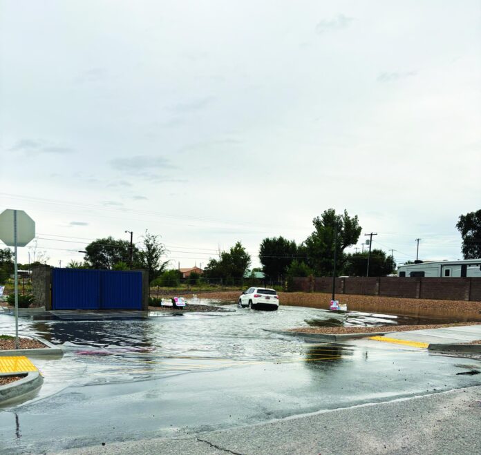 A vehicle makes its way through the flooded 7 Brew parking lot last month after heavy rain dumped on the city.
