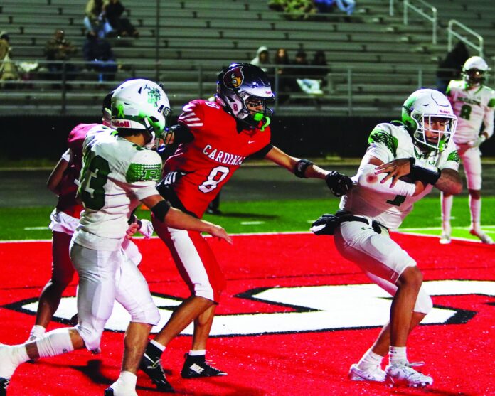 Pojoaque Valley quarterback Josh Gonzales secures the ball after a touchdown run in a 35-27 loss at Robertson recently.